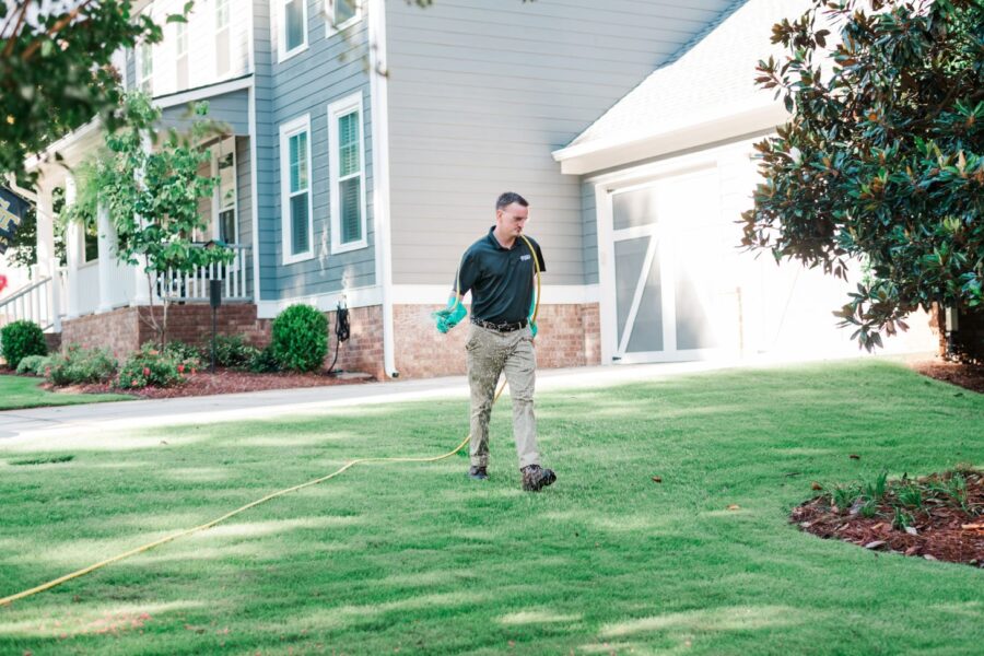 Nature's Turf employee treating a lawn for grubs