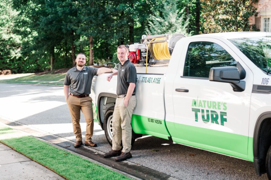 lawn care specialists next to truck