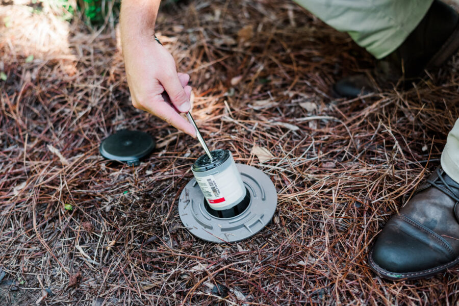 Nature's Turf pest professional maintaining termite bait stations