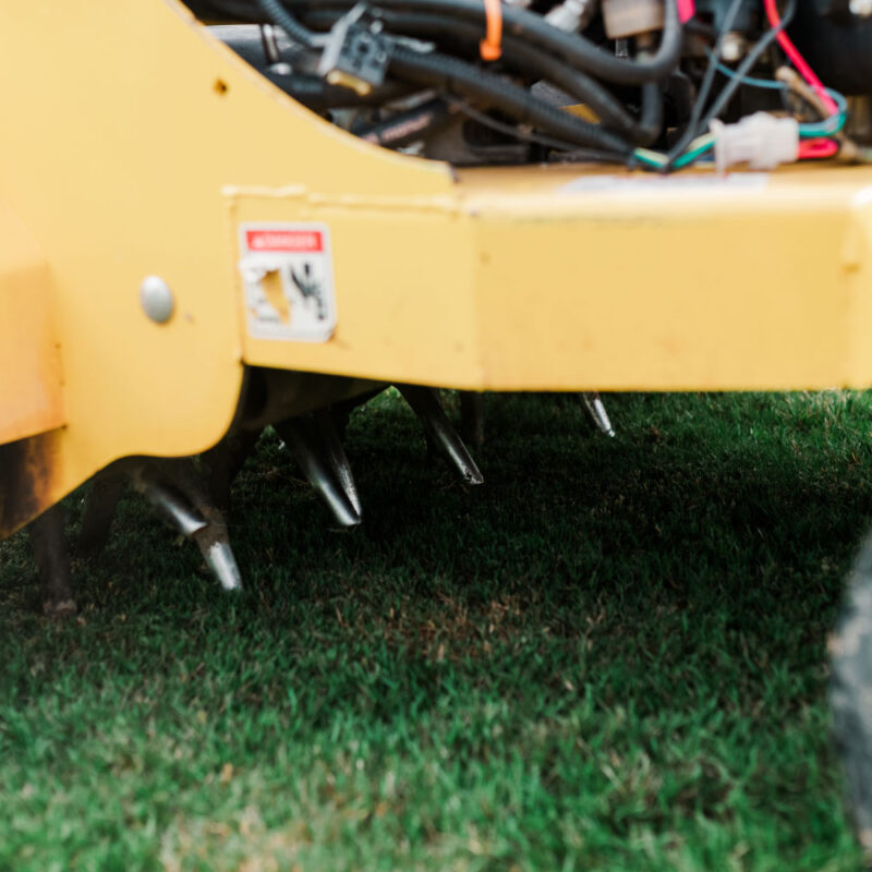 Aerating equipment on a green lawn